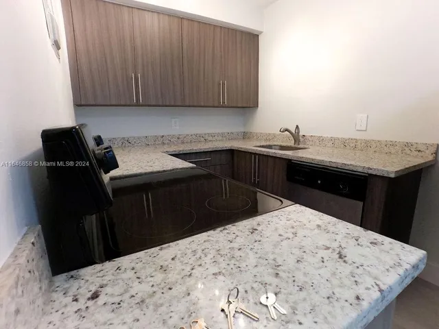 a kitchen with a sink and cabinets