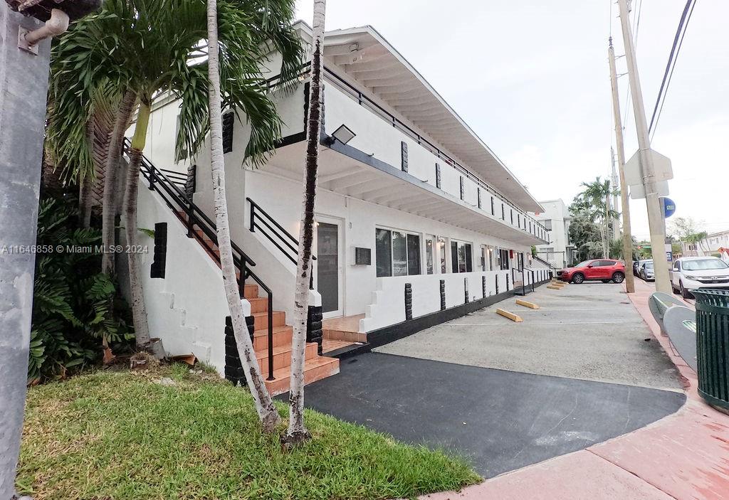 345 85th Street Miami Beach, FL 33141 - Photo 9 of 26 a view of a white house with a large windows and a small yard