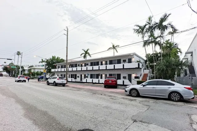 a view of a cars park in front of a building