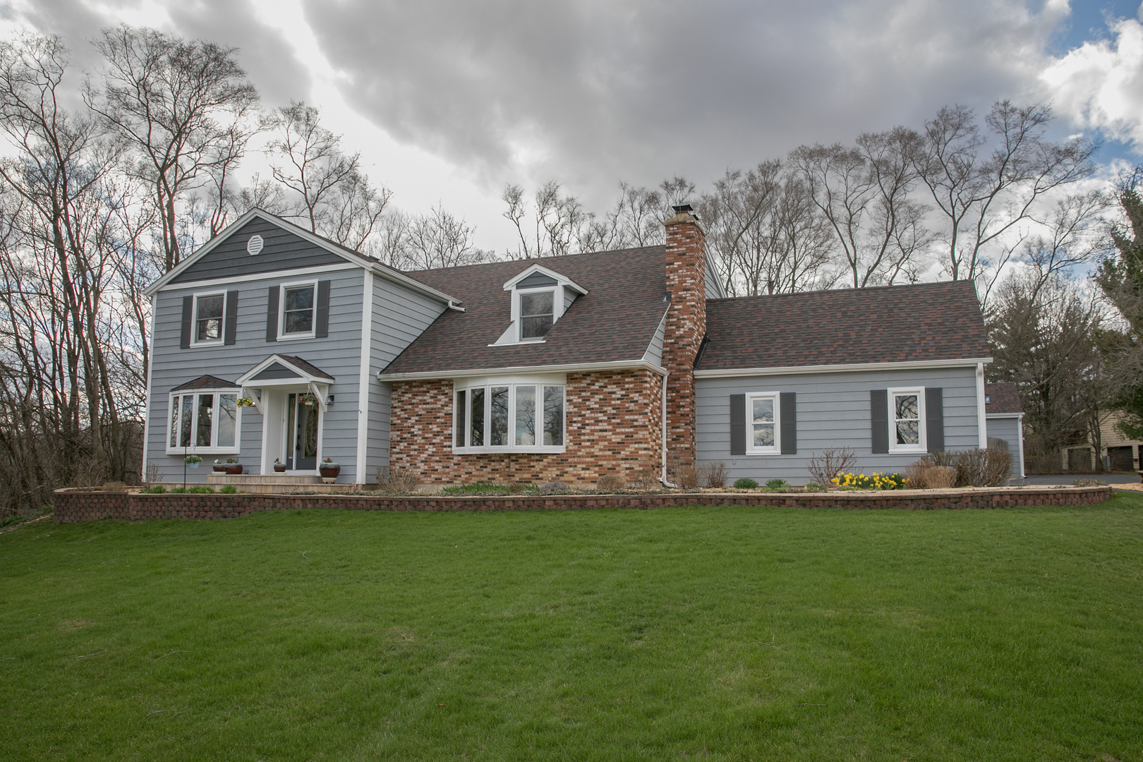 16N560 Sumter Drive Dundee, IL 60118 - Photo 1 of 49 a front view of a house with a yard and trees