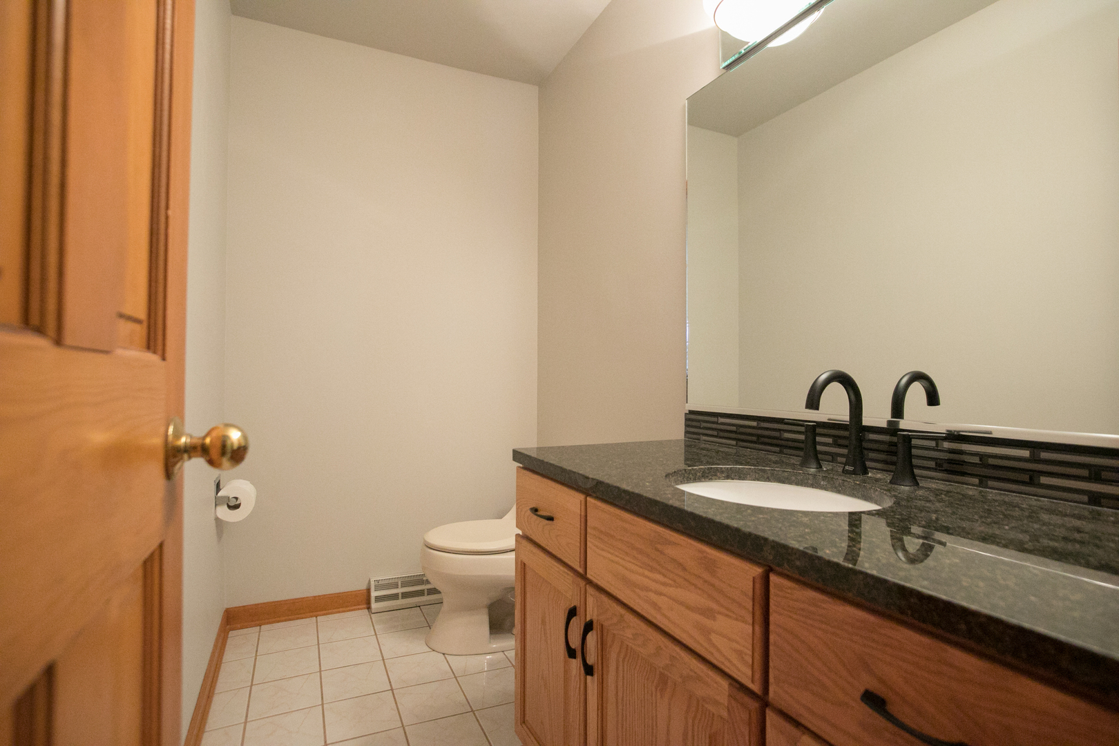 16N560 Sumter Drive Dundee, IL 60118 - Photo 25 of 49 a bathroom with a granite countertop sink a toilet and a mirror