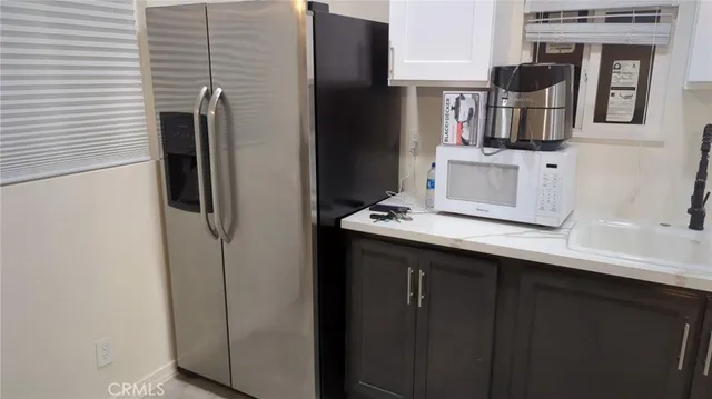 a kitchen with a refrigerator and cabinets