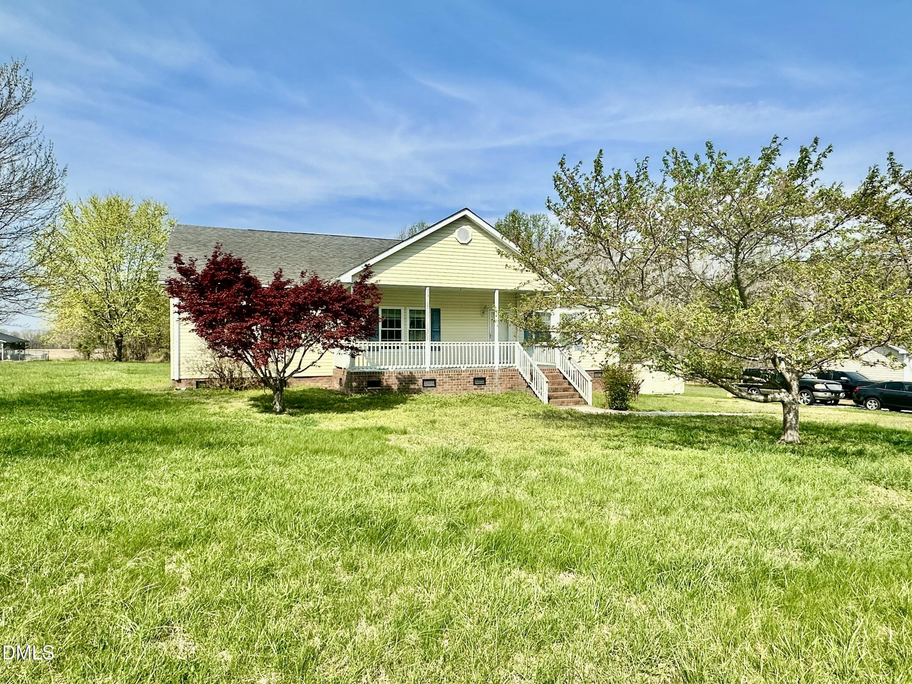 155 Collin Drive Roxboro, NC 27574 - Photo 2 of 20 a front view of a house with garden