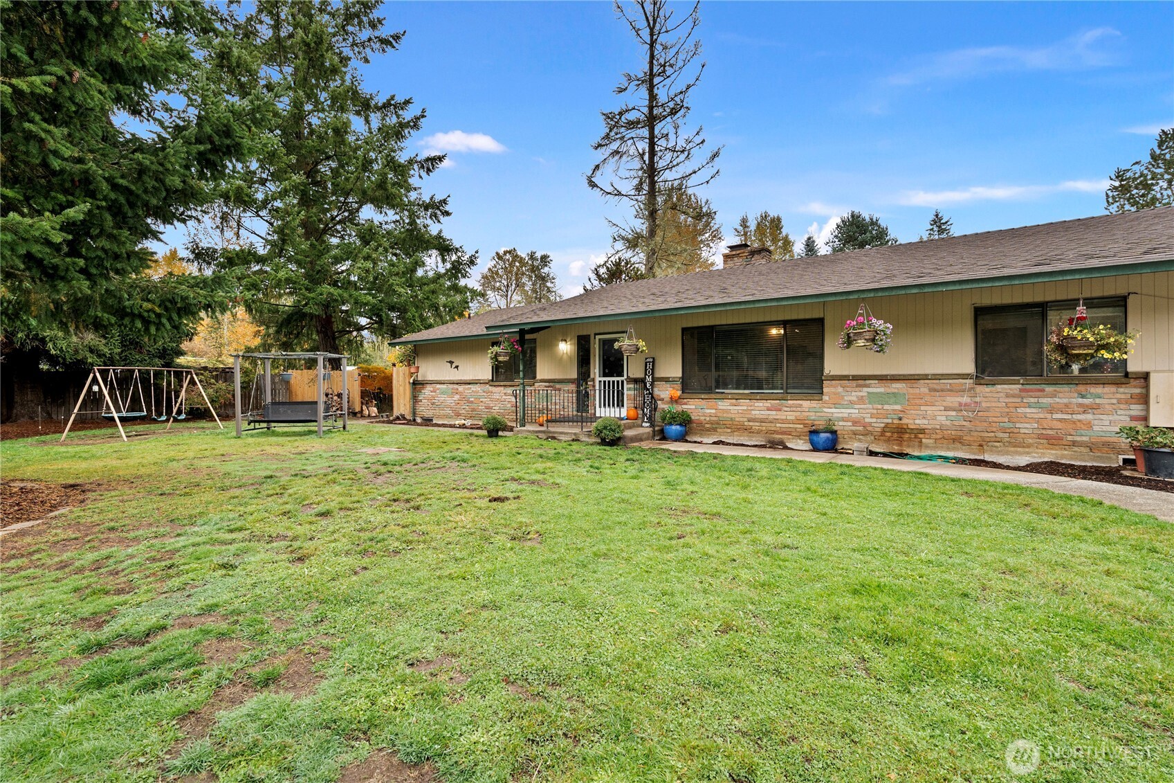 a front view of house with outdoor seating and green space
