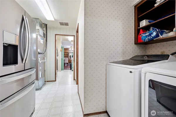 a view of a storage and utility room with washer and dryer