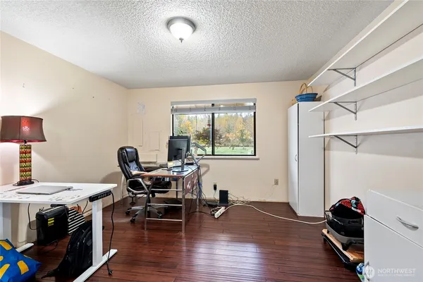 a view of a workspace with furniture and a window