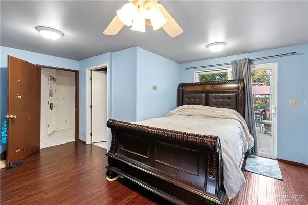 a bed sitting in a bedroom next to a window