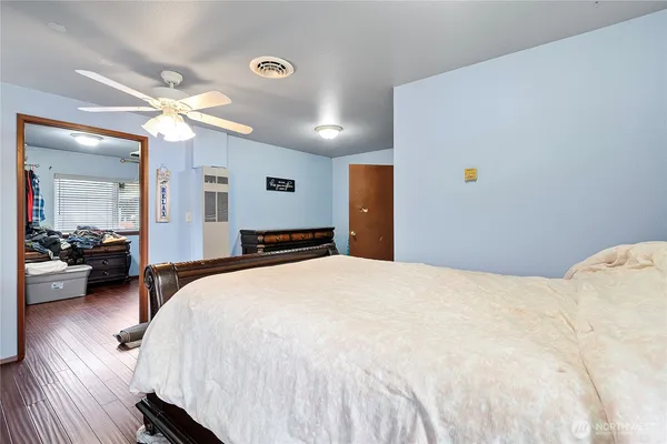 a spacious bedroom with a bed and a large mirror
