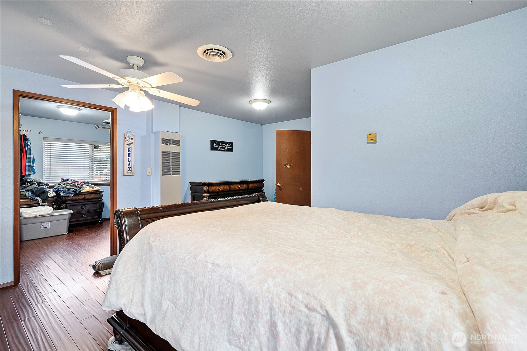 26707 Orville Road East Orting, WA 98360 - Photo 19 of 36 a spacious bedroom with a bed and a large mirror