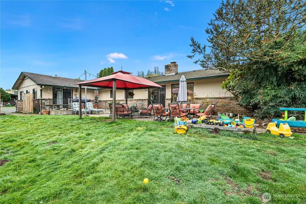 a view of a chairs and table in front of house
