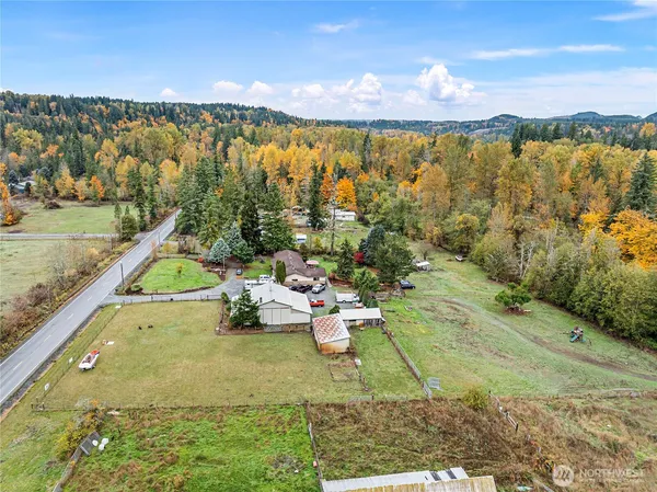 an aerial view of a residential houses with yard