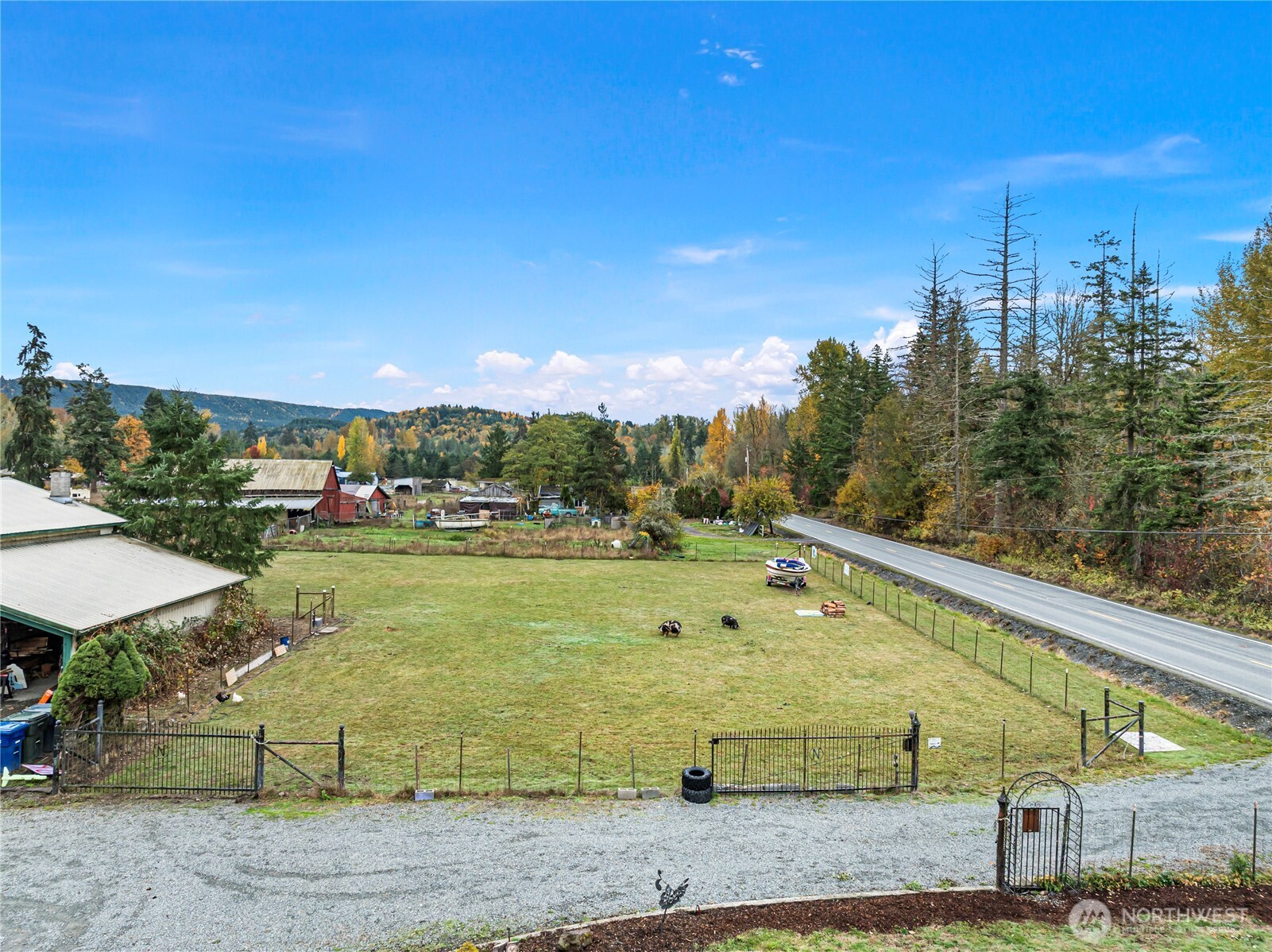 26707 Orville Road East Orting, WA 98360 - Photo 31 of 36 a view of a swimming pool with an outdoor space and seating area