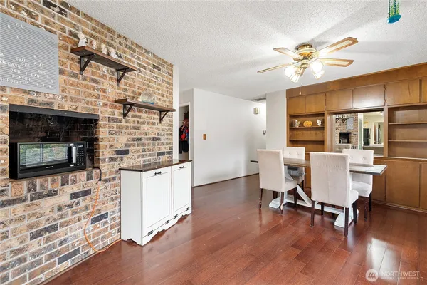 a workspace with wooden floor and a fireplace