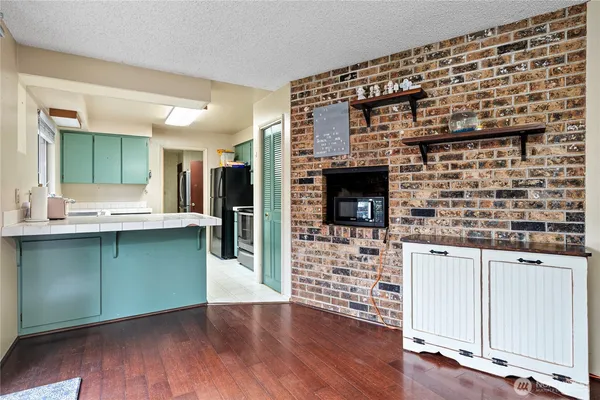 a kitchen with granite countertop a stove and cabinets