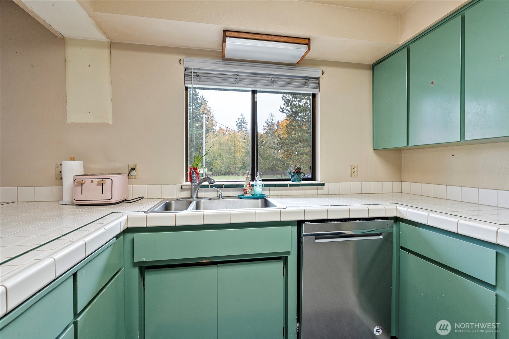 26707 Orville Road East Orting, WA 98360 - Photo 9 of 36 a kitchen with a sink and a window