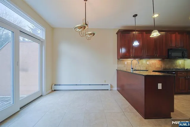 a kitchen with granite countertop a stove and a sink