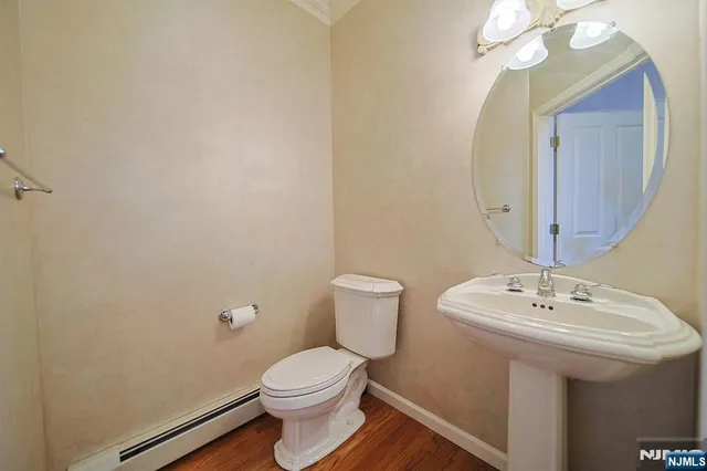 a bathroom with a sink mirror and toilet