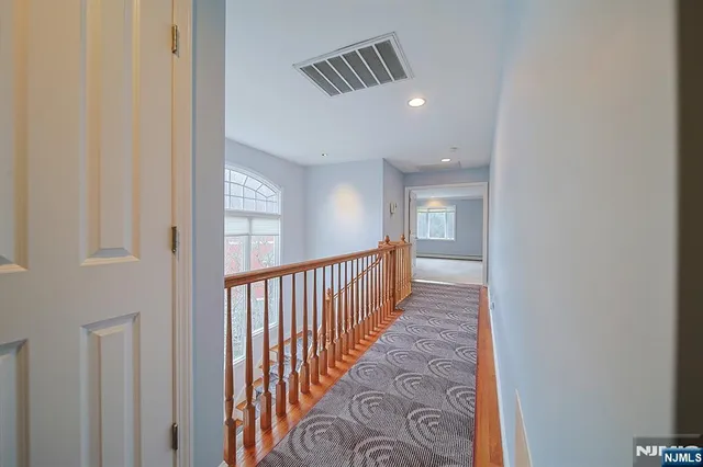 a view of hallway with wooden floor