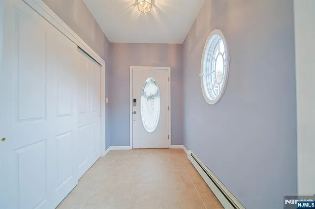 an empty room with mirror on the wall