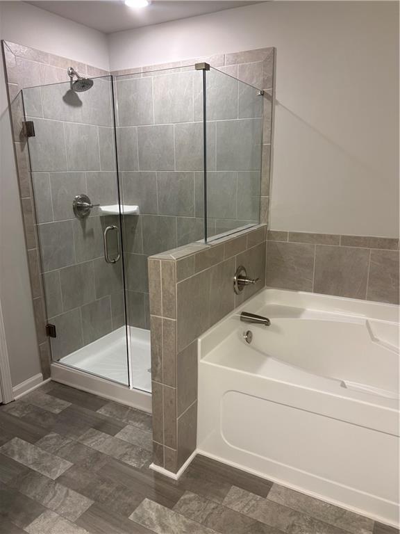 5274 Fox Den Road Oakwood, GA 30566 - Photo 6 of 10 a bathroom with a shower and bathtub