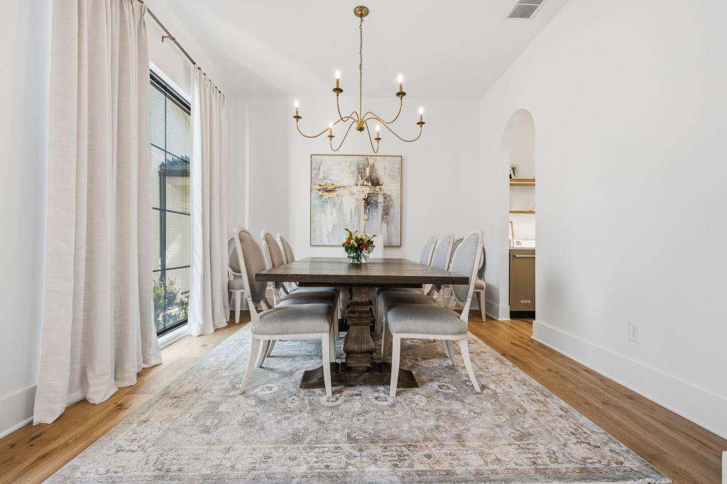 287 Mountain View Ridge Northwest Marietta, GA 30064 - Photo 13 of 77 a dining room with wooden floor a chandelier a wooden table and chairs