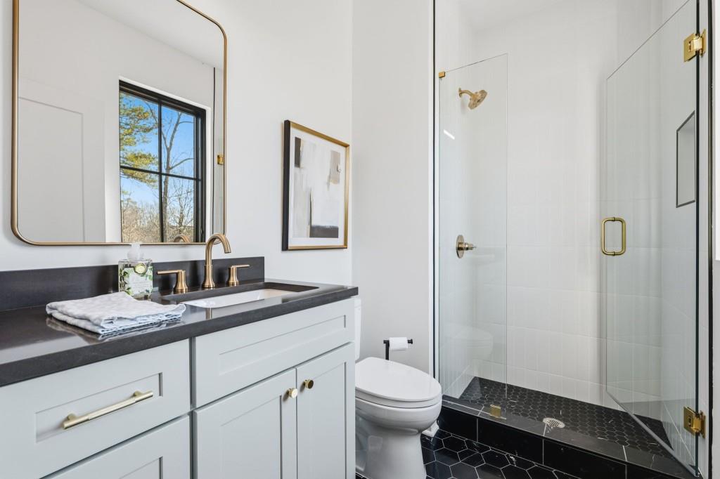 287 Mountain View Ridge Northwest Marietta, GA 30064 - Photo 50 of 77 a bathroom with a granite countertop sink toilet a mirror and shower