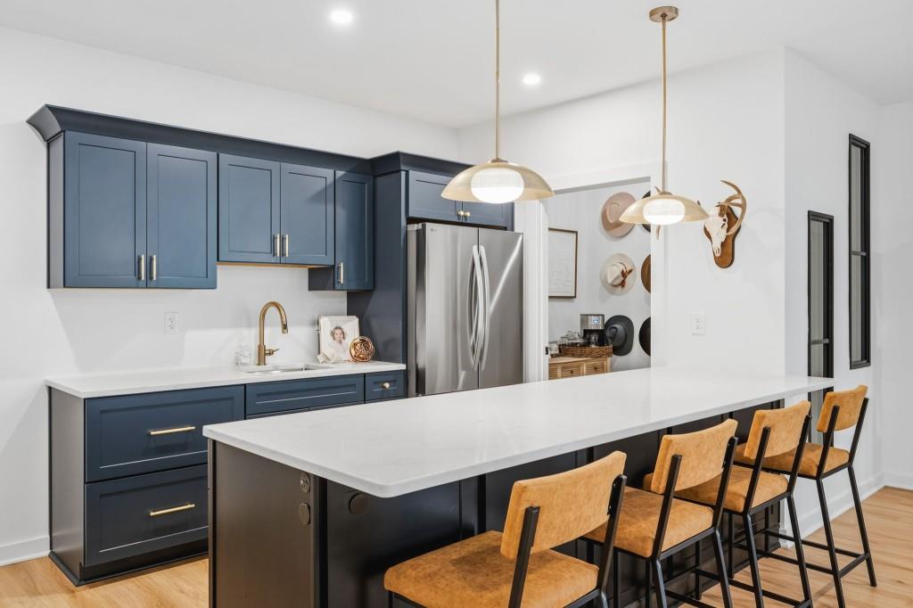 287 Mountain View Ridge Northwest Marietta, GA 30064 - Photo 62 of 77 a kitchen with stainless steel appliances kitchen island a table chairs in it and wooden floors