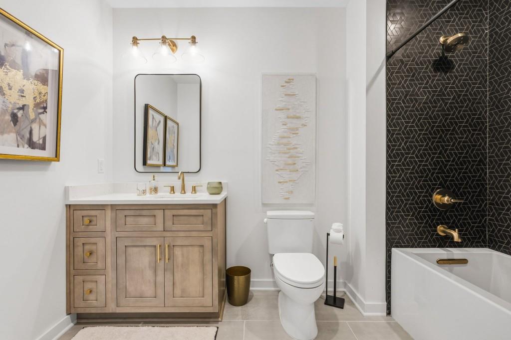 287 Mountain View Ridge Northwest Marietta, GA 30064 - Photo 71 of 77 a bathroom with a toilet a sink a mirror a bathtub and shower