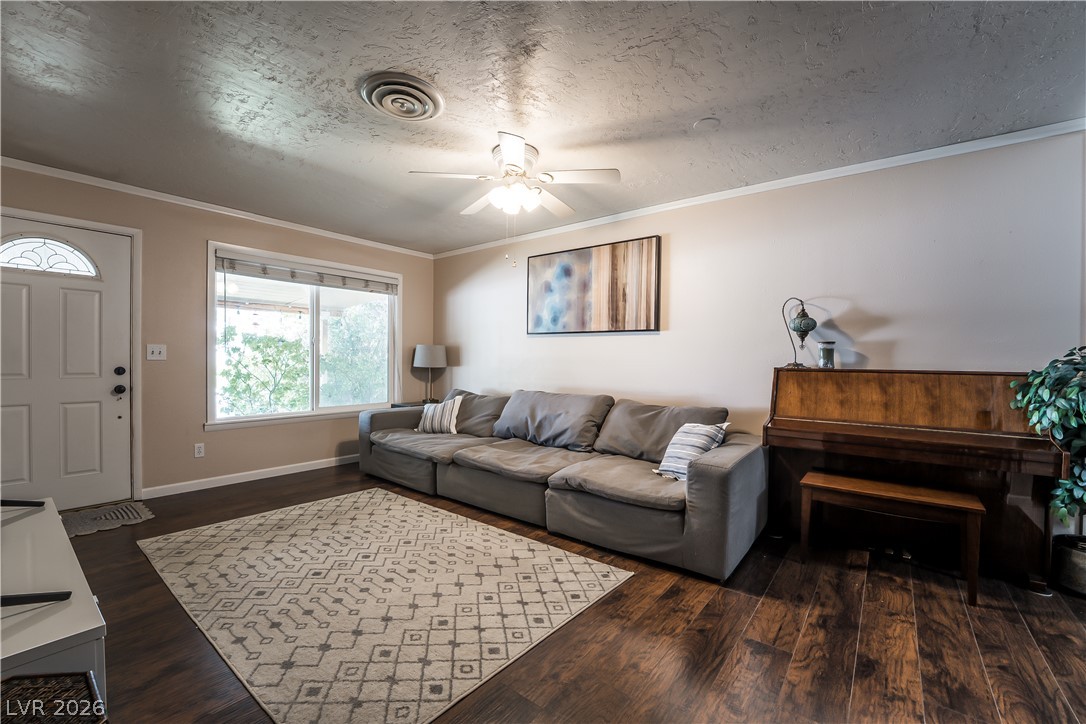 1324 Appaloosa Road Boulder City, NV 89005 - Photo 4 of 42 A well-lit gathering space with rich hardwood floors and an inviting atmosphere.
