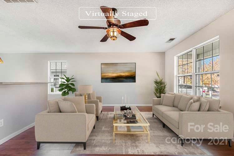 3021 Winners Circle Southwest Concord, NC 28025 - Photo 2 of 20 a living room with furniture ceiling fan and a window