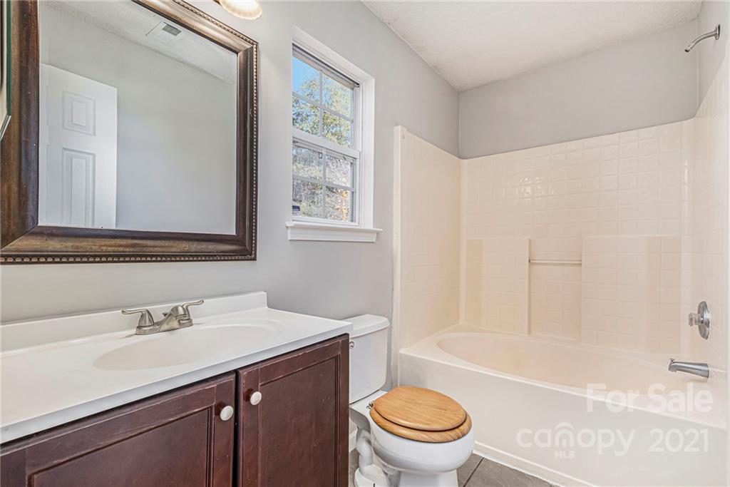 3021 Winners Circle Southwest Concord, NC 28025 - Photo 16 of 20 a bathroom with a sink toilet and shower