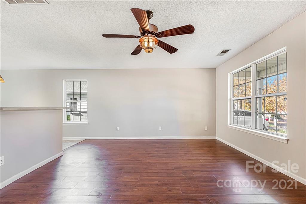 3021 Winners Circle Southwest Concord, NC 28025 - Photo 3 of 20 a view of empty room with wooden floor and window