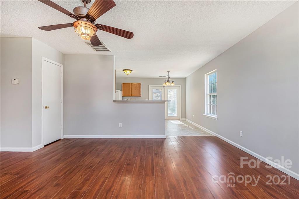 3021 Winners Circle Southwest Concord, NC 28025 - Photo 4 of 20 wooden floor in an empty room with a window