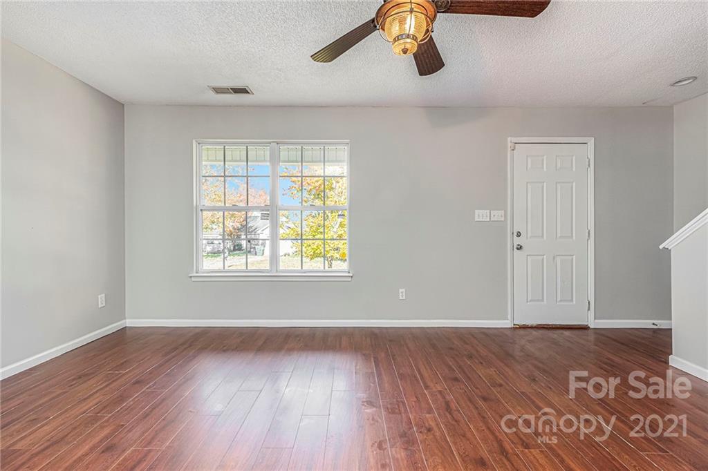 3021 Winners Circle Southwest Concord, NC 28025 - Photo 5 of 20 wooden floor in an empty room with a window