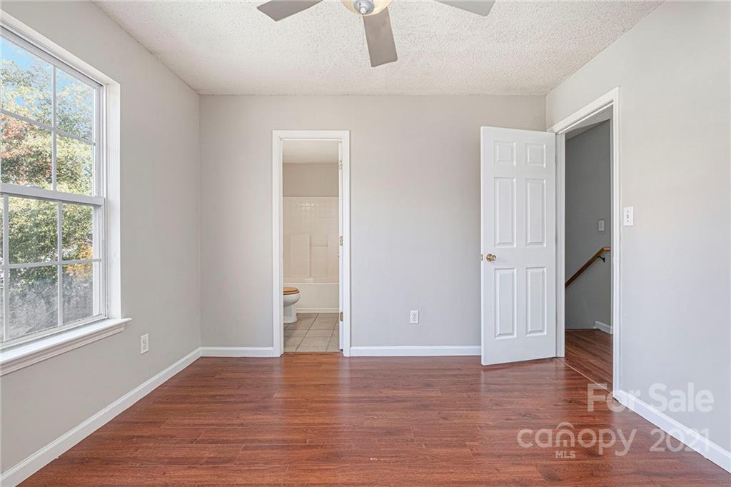 3021 Winners Circle Southwest Concord, NC 28025 - Photo 10 of 20 a view of an empty room with wooden floor and a window