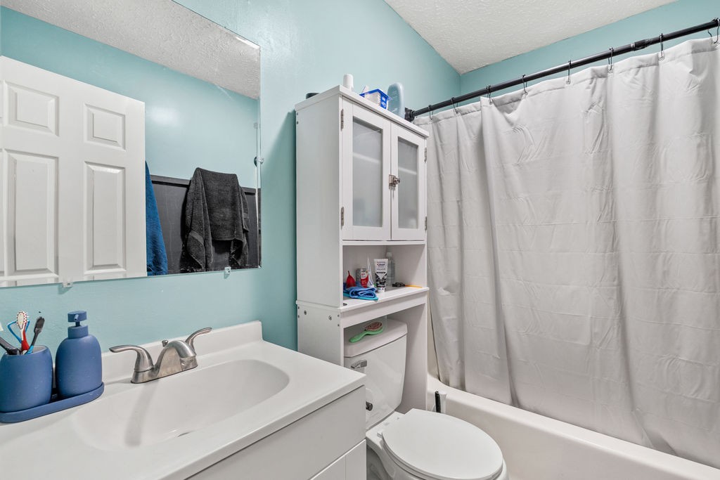 250 McDeerman Road Jacksboro, TN 37757 - Photo 14 of 25 a bathroom with a sink a toilet and shower curtain