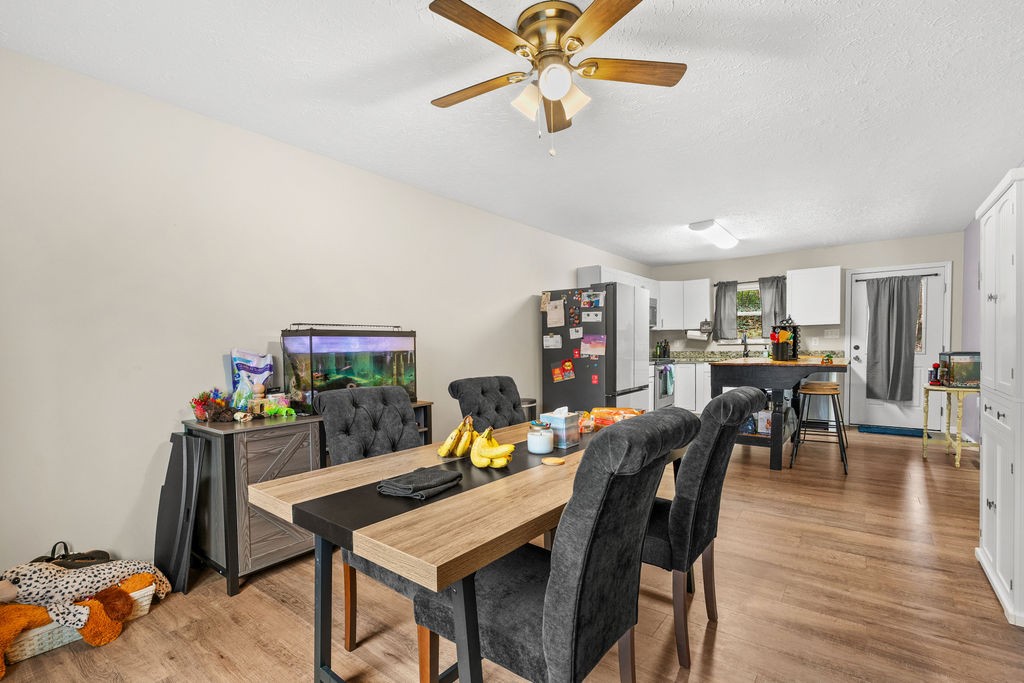 250 McDeerman Road Jacksboro, TN 37757 - Photo 7 of 25 a view of a dining room with furniture and wooden floor