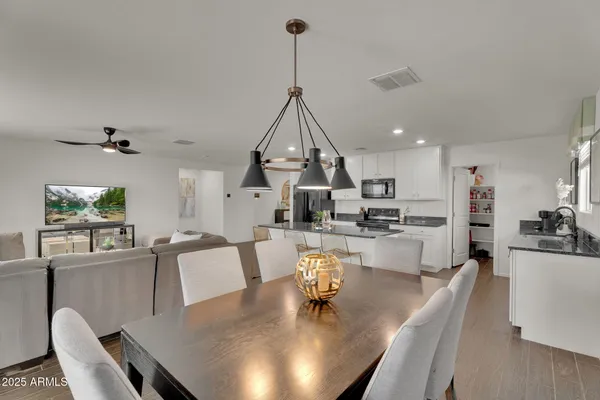 a cabinet with lots of clutter and white cabinets