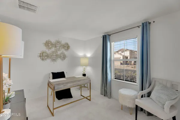 a bedroom with a bed and chandelier