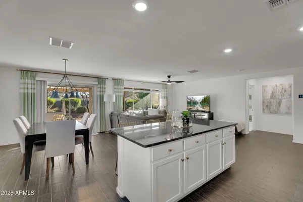 a kitchen with stainless steel appliances kitchen island granite countertop a sink and cabinets