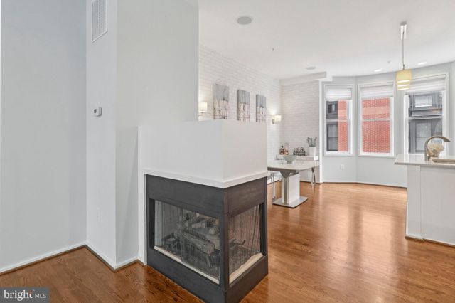 a kitchen with a sink cabinets and wooden floor