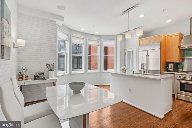 a kitchen with stainless steel appliances a sink stove and cabinets