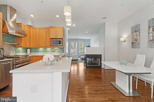 a kitchen with stainless steel appliances a refrigerator sink and stove