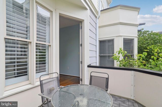 a view of staircase with white walls and a window