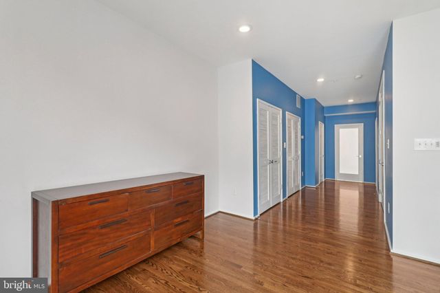 a bathroom with a granite countertop sink a mirror and shower