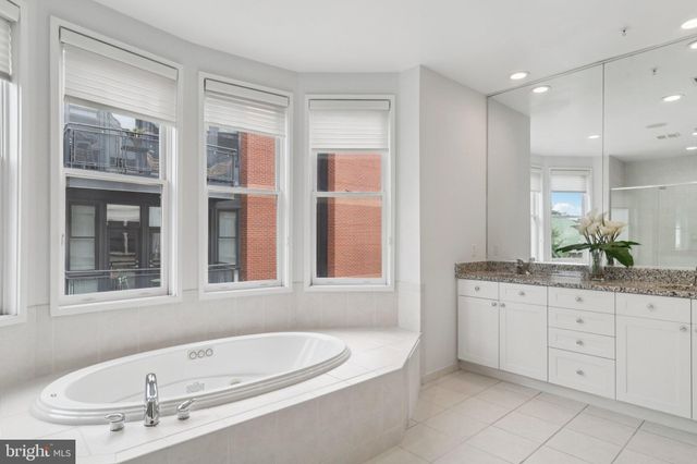 a bathroom with a bathtub shower and toilet