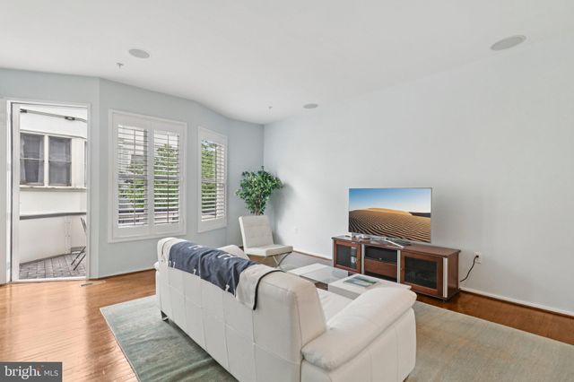 a living room with furniture and a ceiling fan