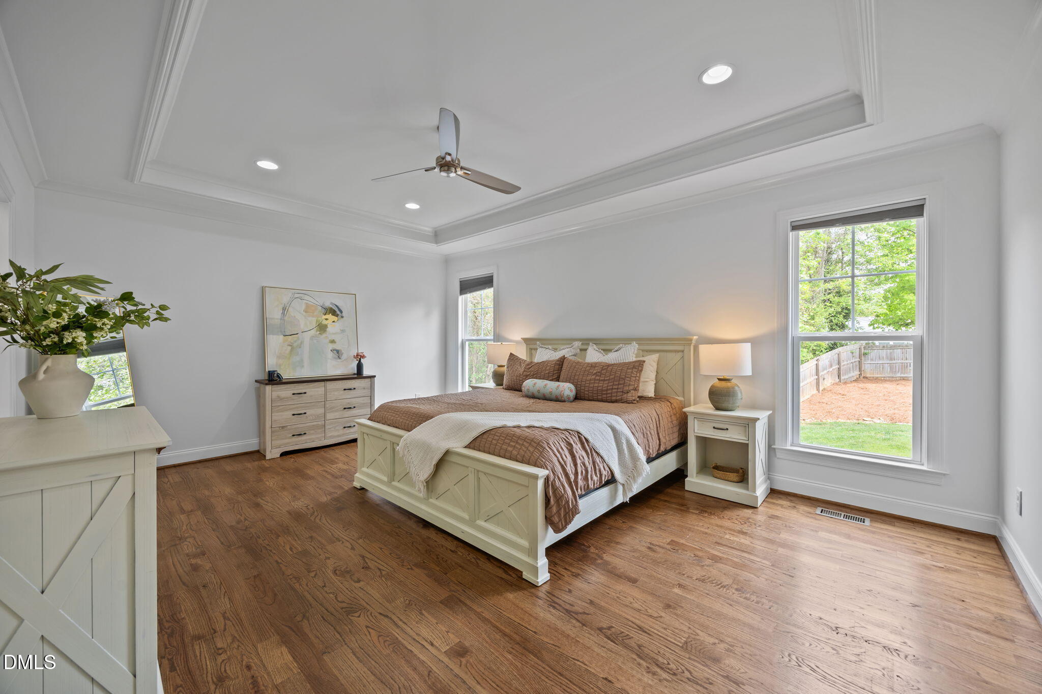804 Hartford Road Raleigh, NC 27610 - Photo 10 of 26 a bedroom with a large bed and a chandelier