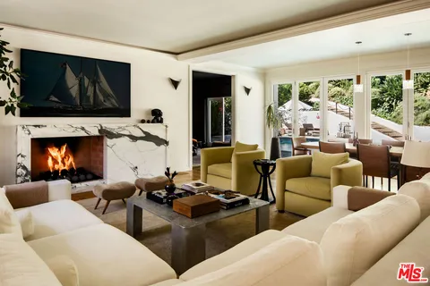 a living room with furniture fireplace and a flat screen tv