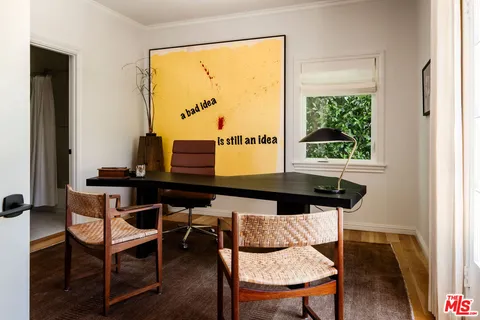 a table and chairs in a room next to a window